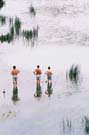 Three fishermen trying their luck - looks like an excuse to stand in cool water